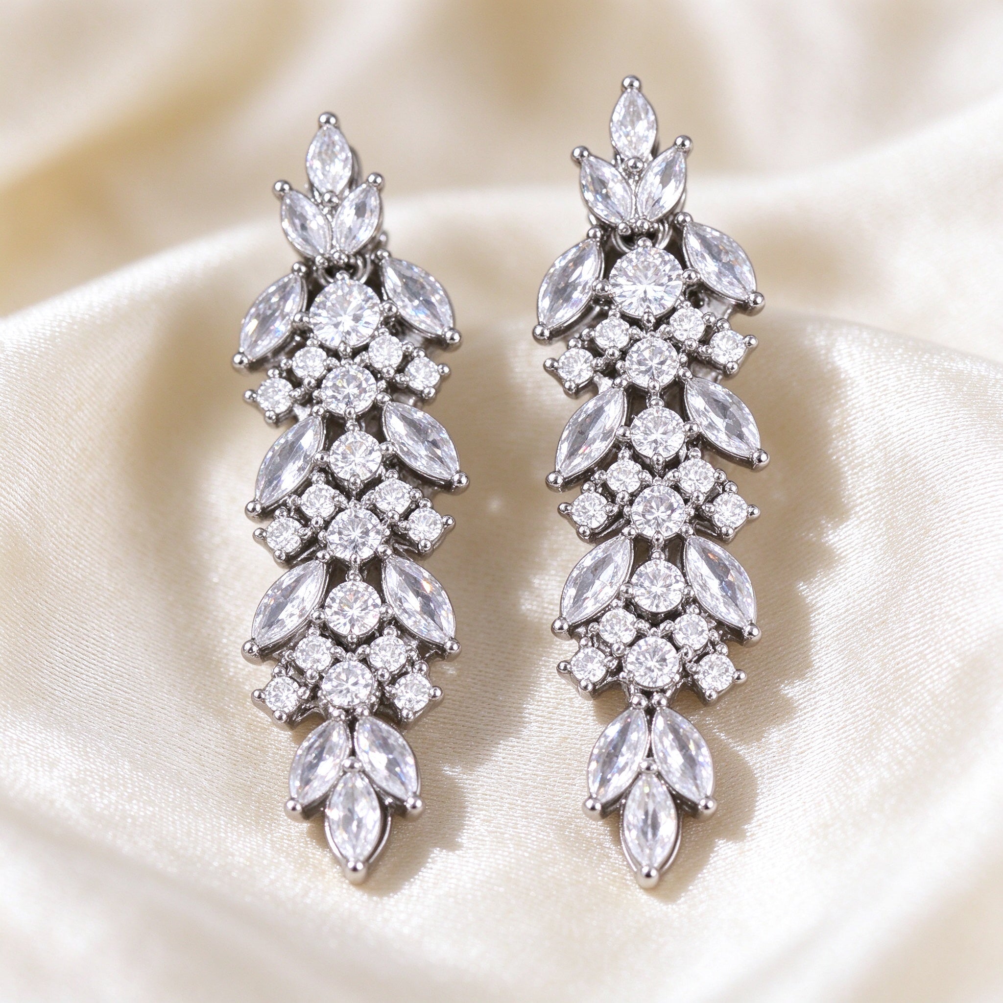Macro of cascading marquise and round CZ leaf drop earrings