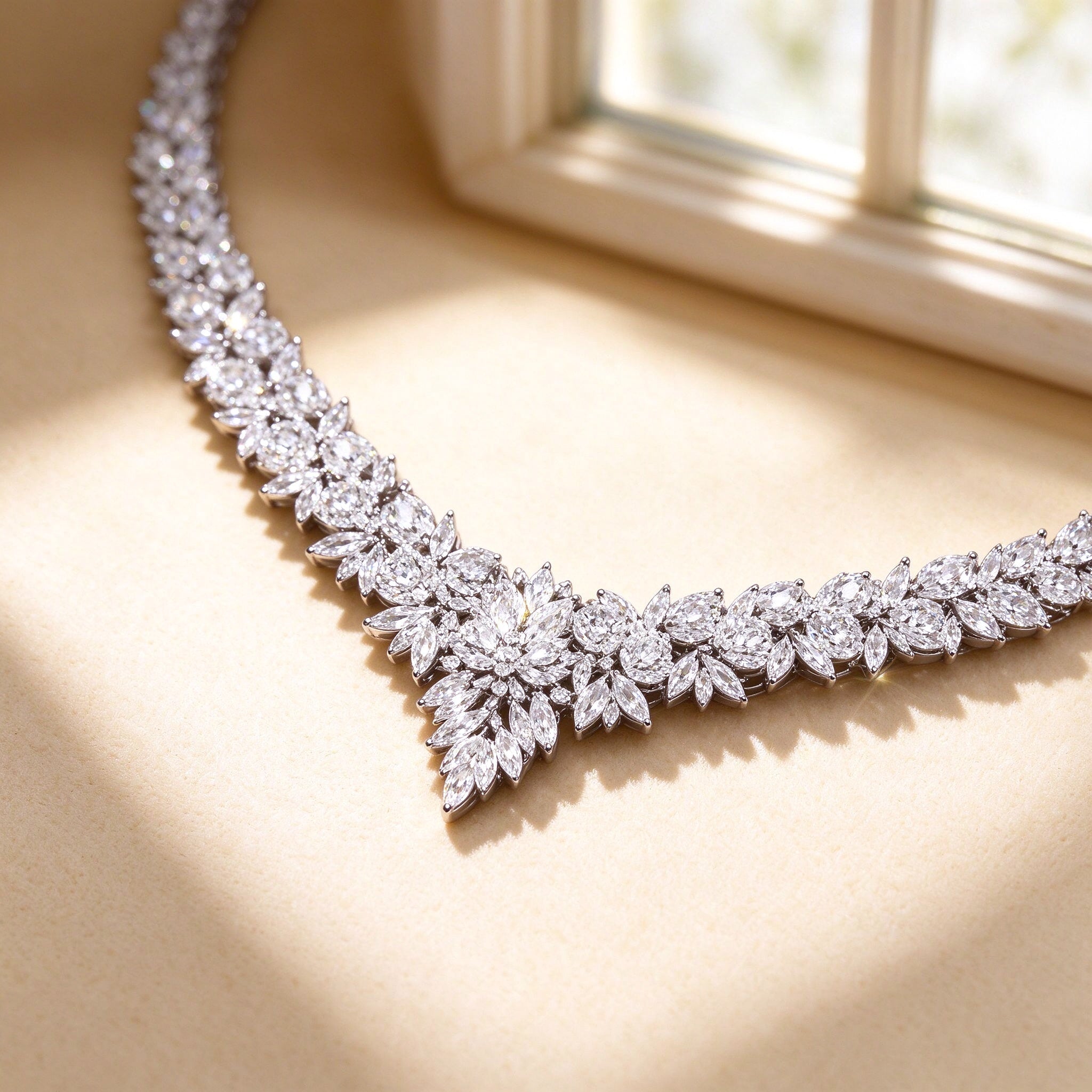 Macro close-up of The Blair graduated marquise-cut clear cubic zirconia V-line on cream silk