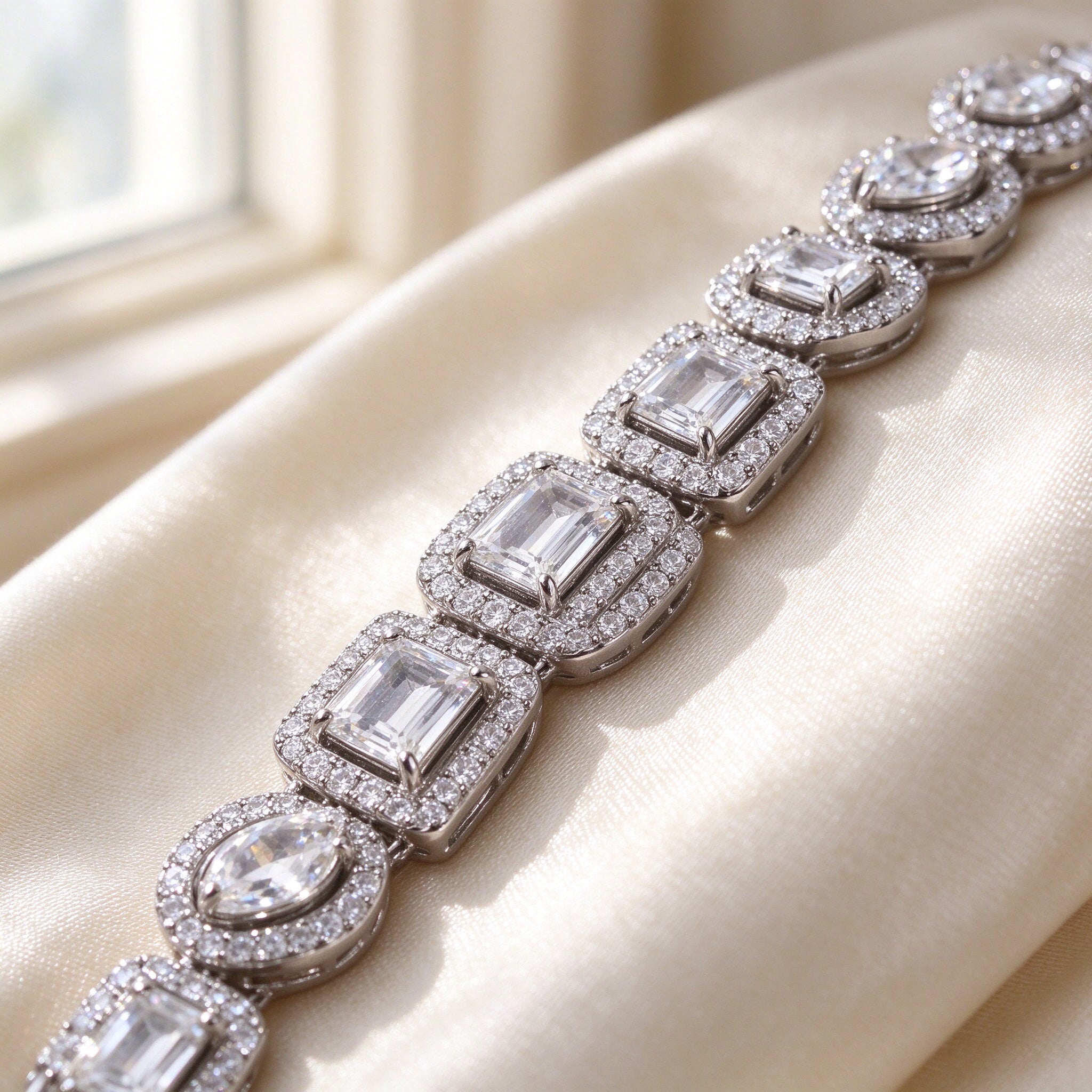 Macro detail of The Celestia Wedding Suite alternating emerald and pear cut CZ with micro-pavé halos