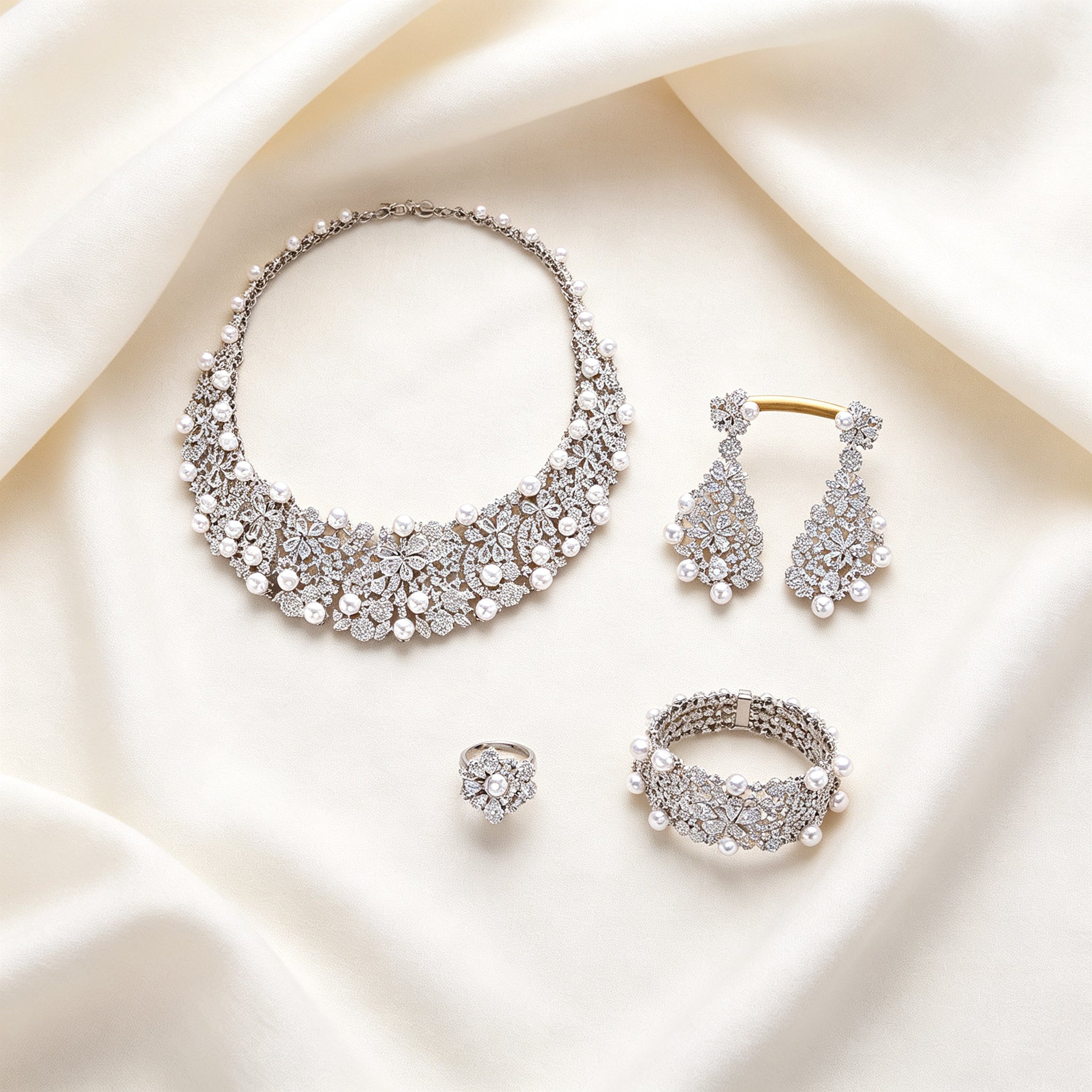 Flat lay of The Eclipse four-piece bridal jewelry set on ivory linen