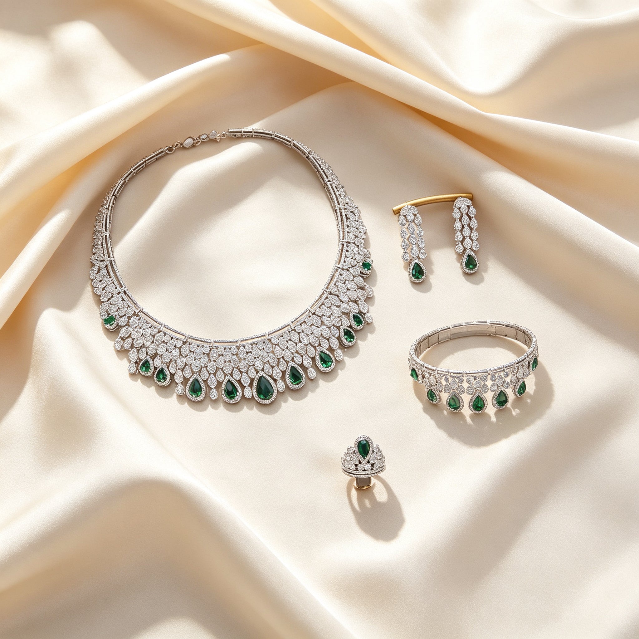 Flat lay of The Estelle Crystal Suite four-piece set on draped ivory champagne silk
