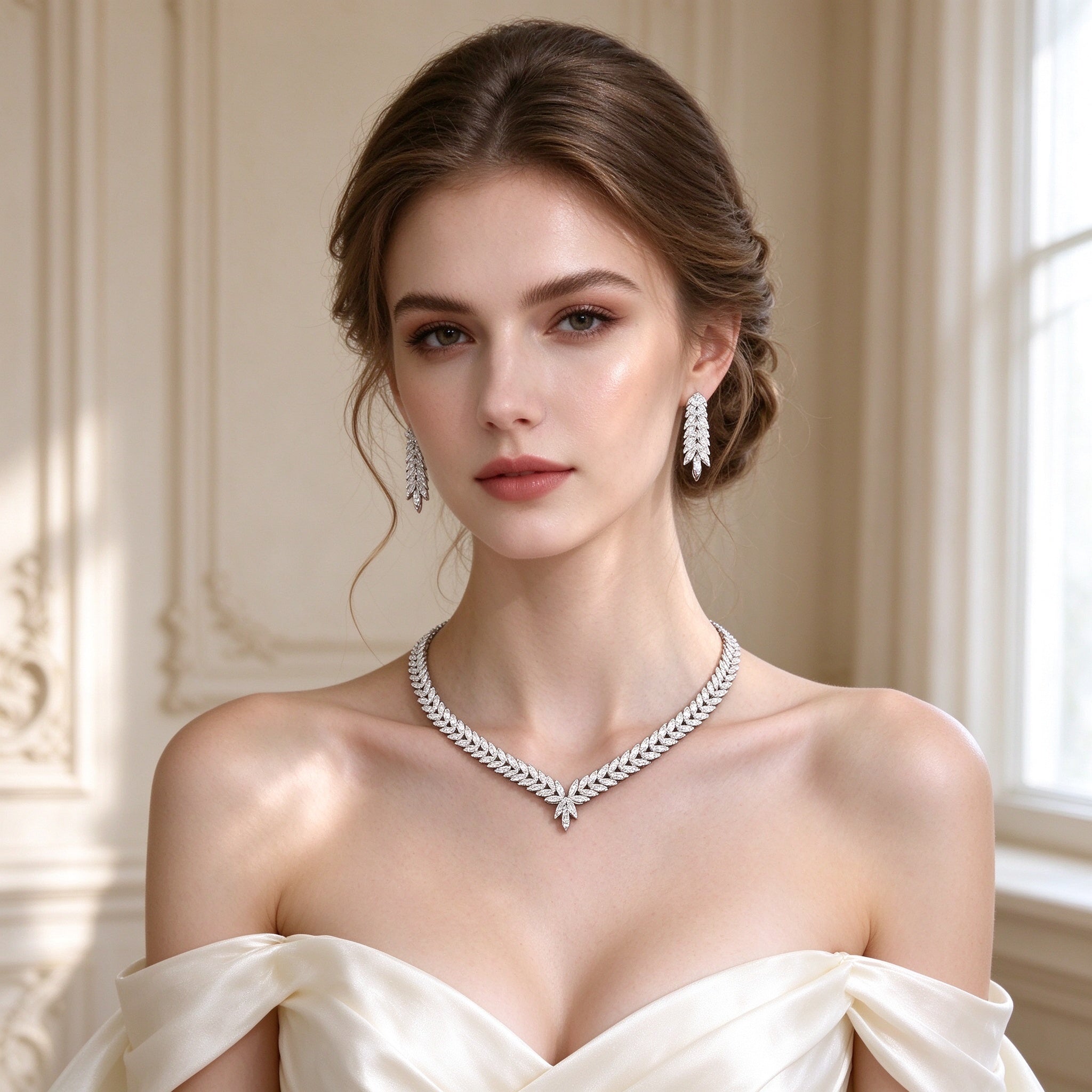 Bridal model wearing The Gardenia Wedding Suite marquise-leaf V-necklace and cascading leaf drop earrings