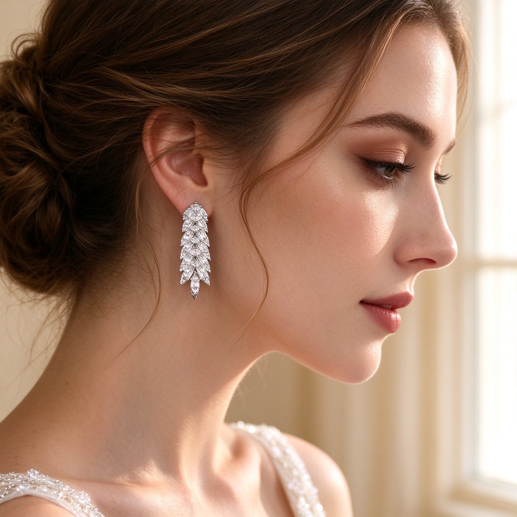 Close-up side profile of a bride wearing The Gardenia Wedding Suite cascading leaf drop earring