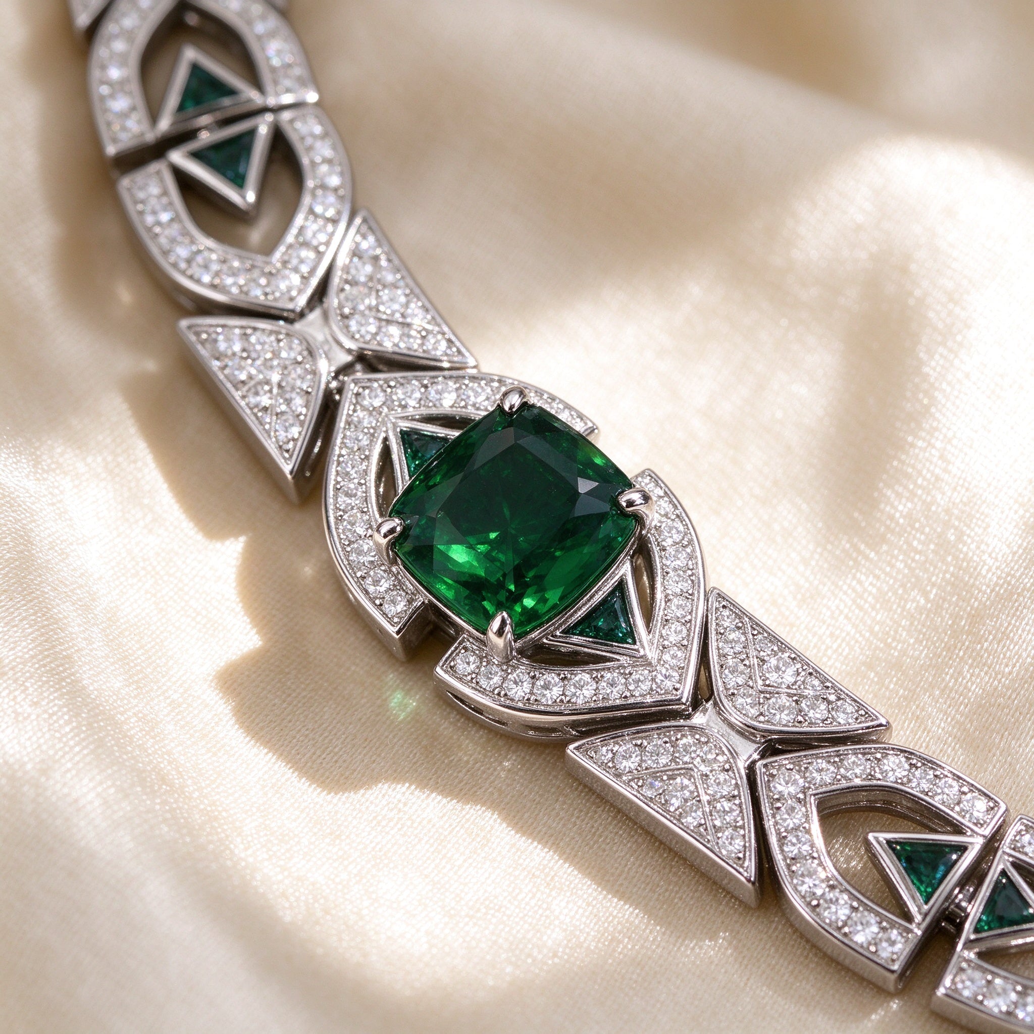 Macro detail of emerald-green cushion CZ center stone and pavé triangular links