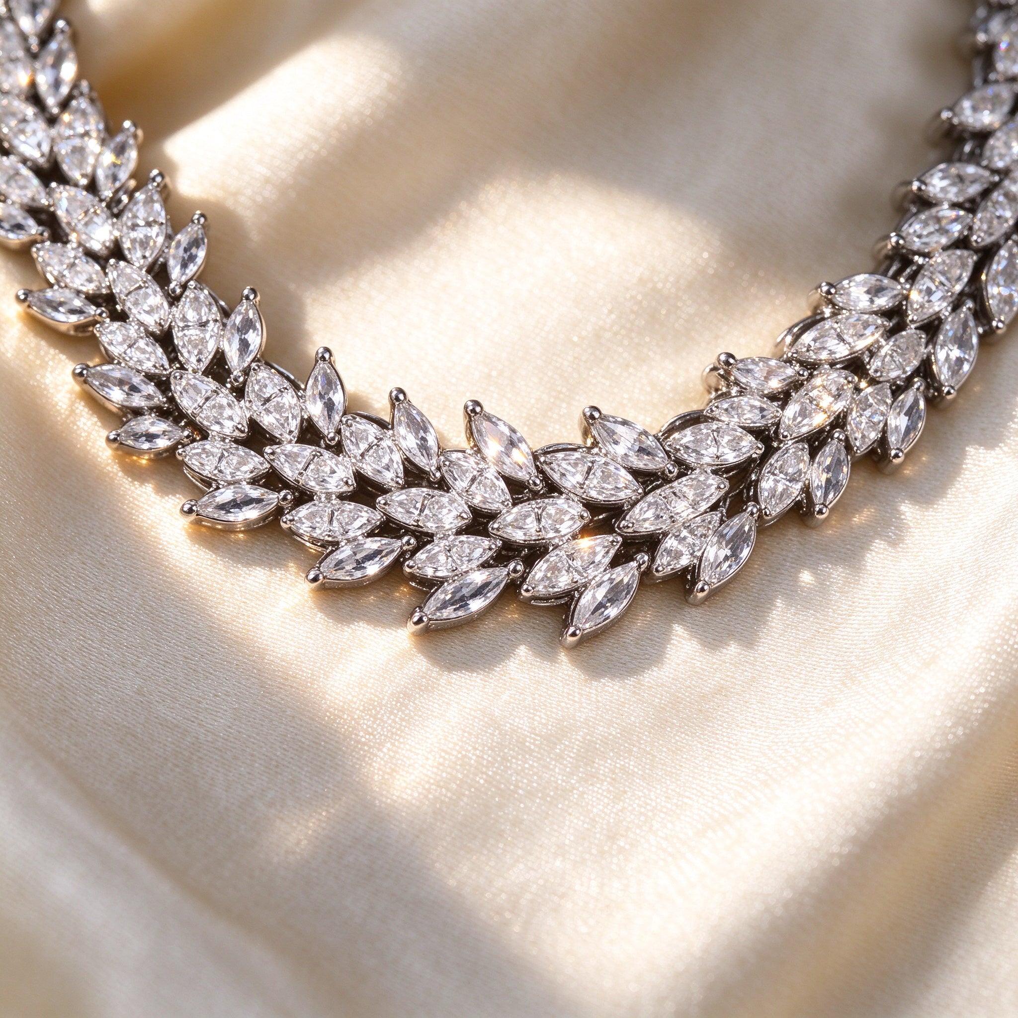 Macro detail of The Nova Crystal Parure tiered tapered baguette and round pavé CZ collar necklace