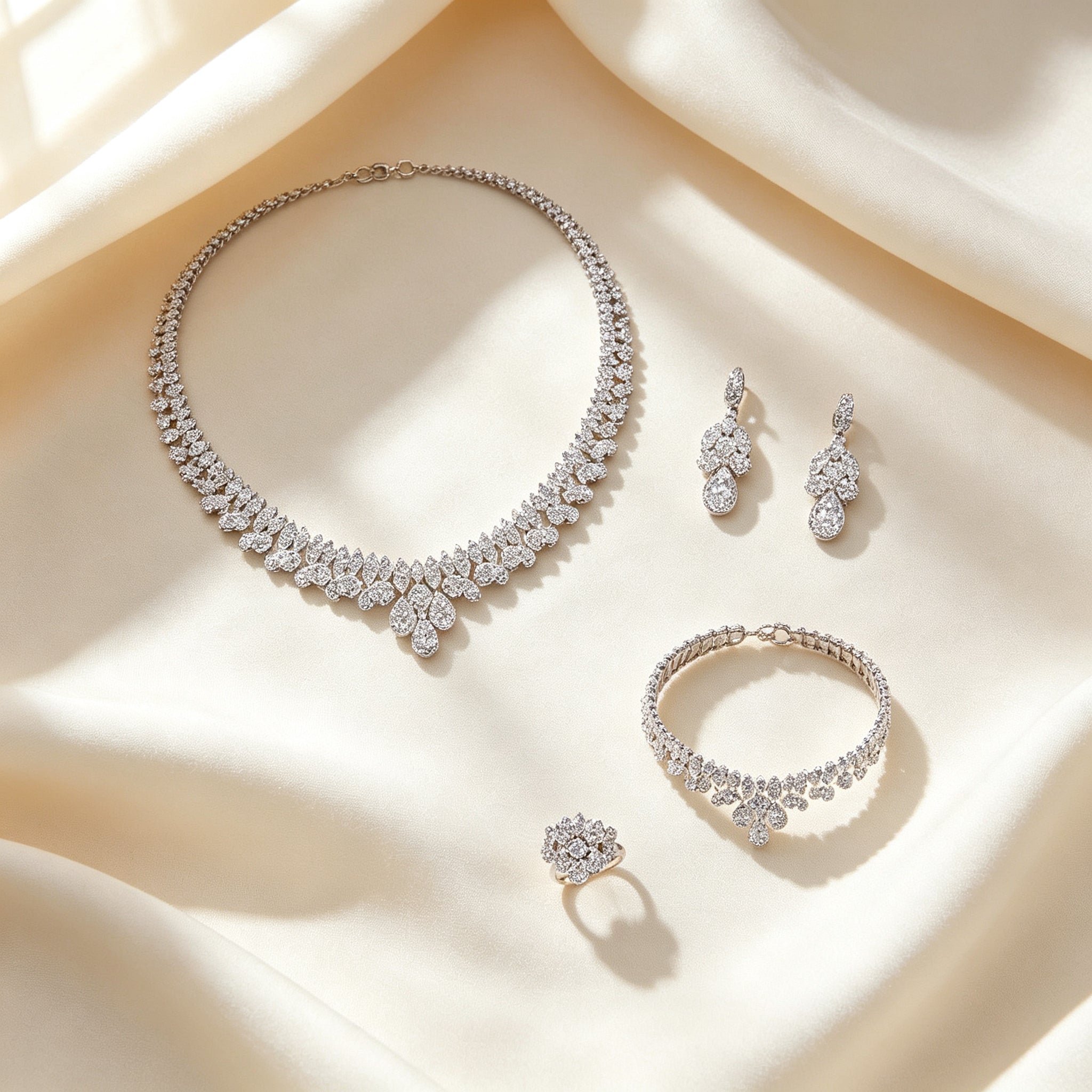 Top-down flat lay of The Rose Crystal Parure necklace, earrings, bracelet and ring