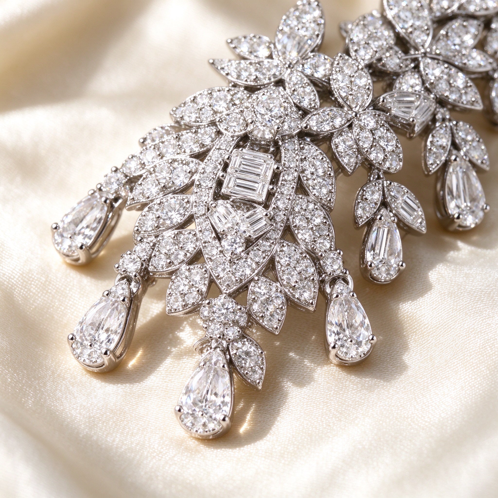 Macro of The Selene Bridal Parure pavé botanical leaf detail with baguette and pear-shaped cubic zirconia drops