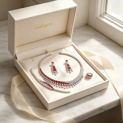 The Astra Wedding Suite four-piece ruby-red CZ set presented in a Talisyra ivory satin-lined gift box