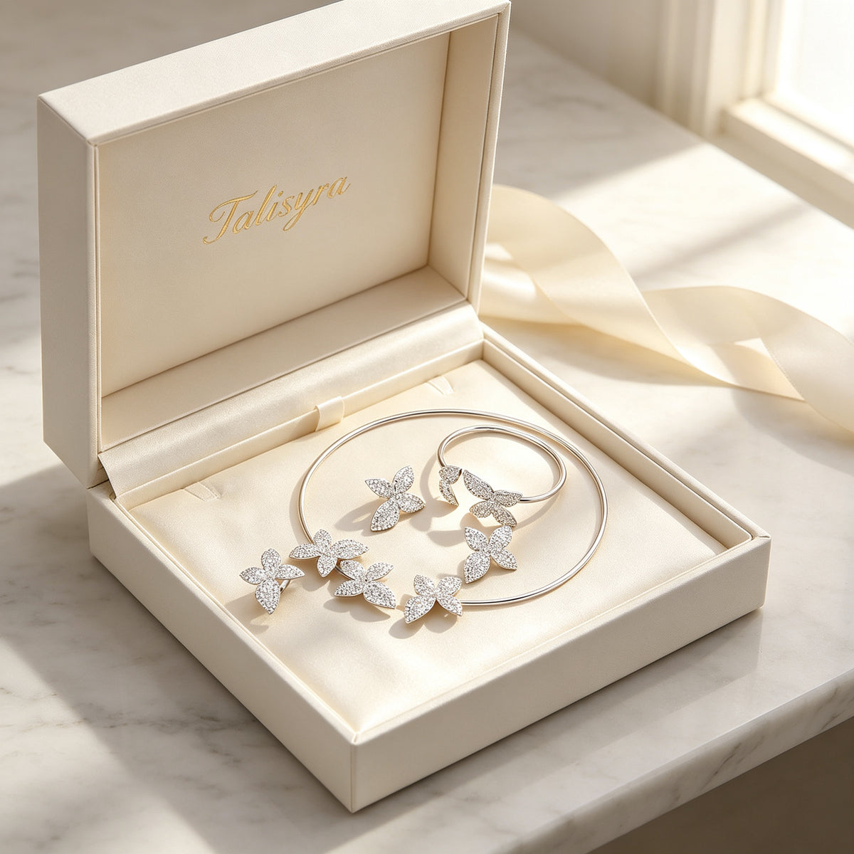 The Stella Bridal Set pavé orchid four-piece set presented in a Talisyra ivory satin-lined gift box