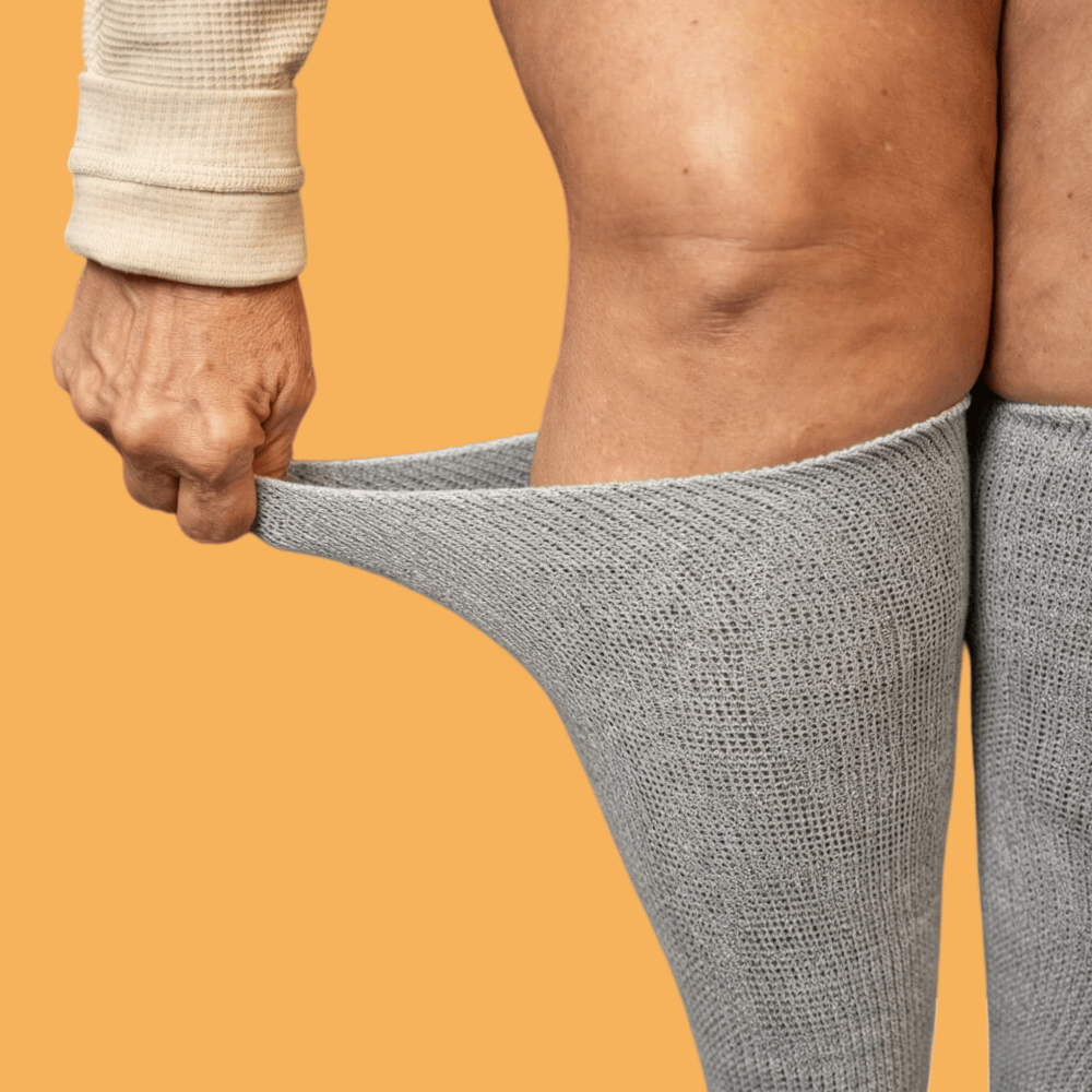 Side view of the black diabetic foot massage socks: featuring a loose, non-constricting cuff and a body that fits snugly and comfortably.