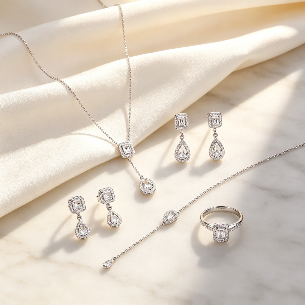 Four-piece CZ set flat lay on silk
