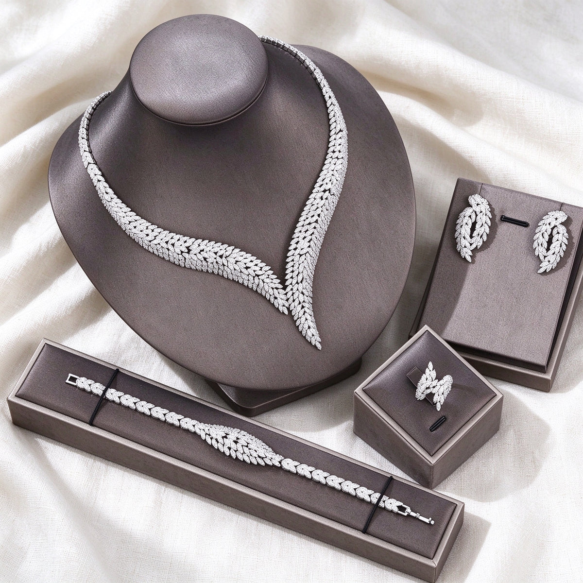 Silver-tone Dawn bridal jewelry set flat lay on ivory linen