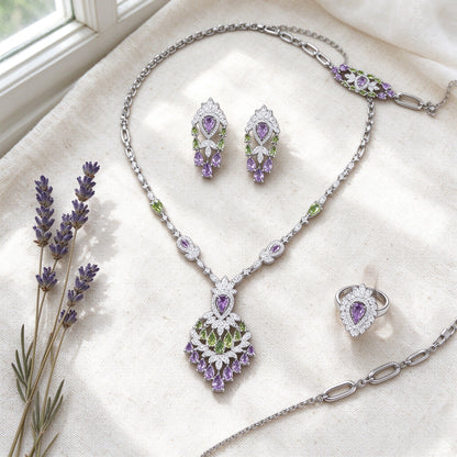 Overhead flat lay of The Wheat Crystal Parure necklace, earrings, bracelet and ring on ivory linen with dried lavender
