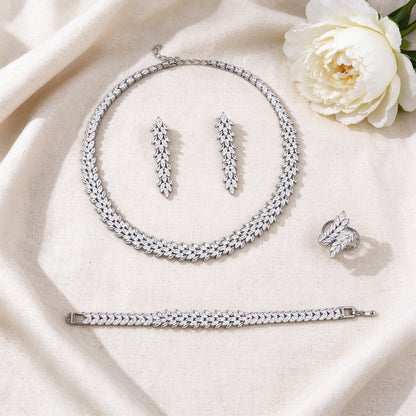 Flat lay of The Nova Bridal Set four-piece bridal jewelry on ivory linen