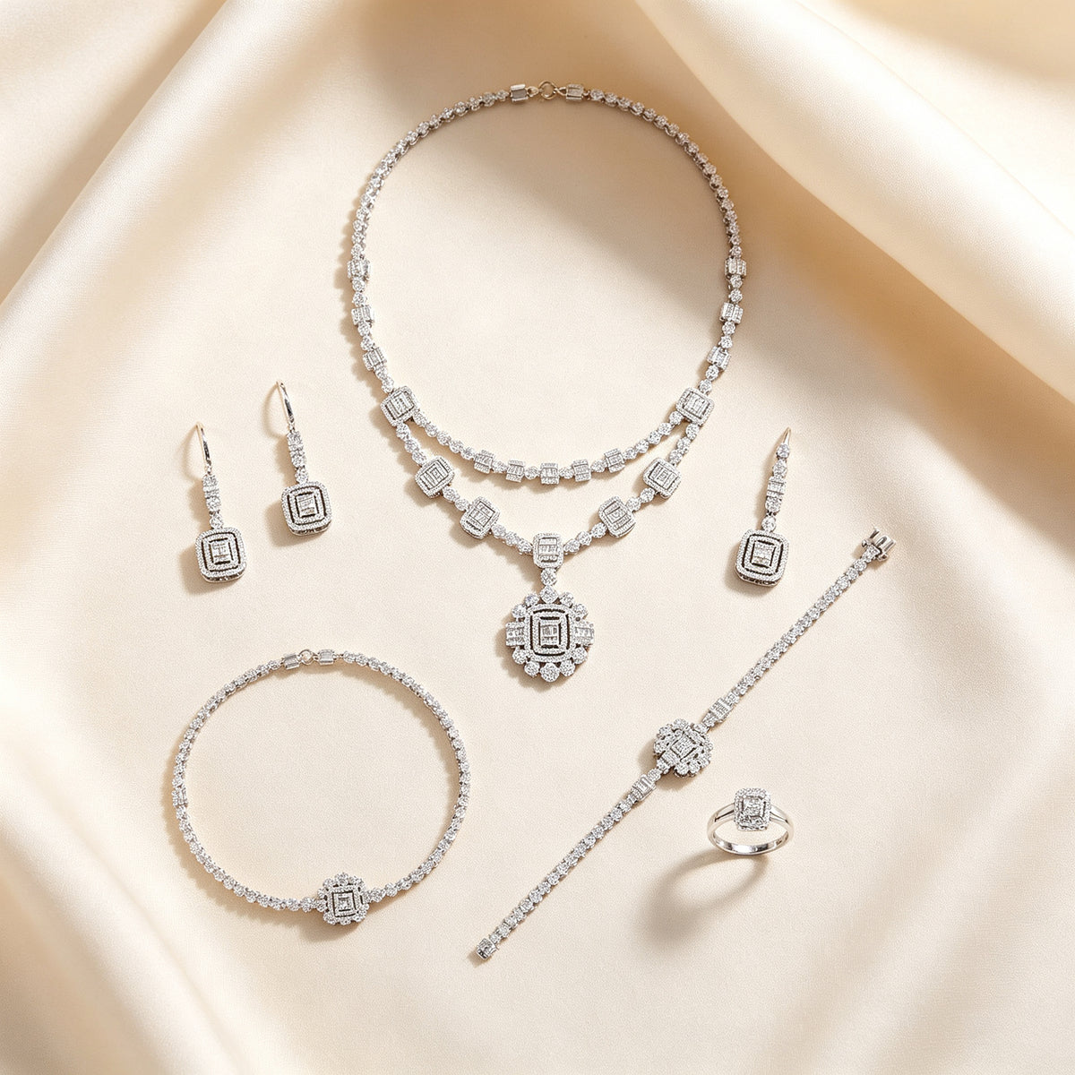 Flat lay of The Nadir four-piece Art Deco bridal jewelry set on cream silk