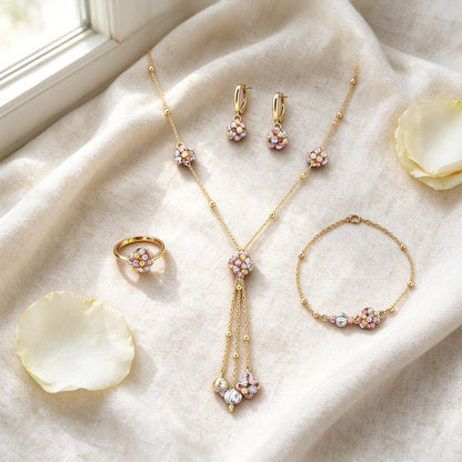 Flat lay of Poppy necklace, earrings, ring and bracelet on cream linen