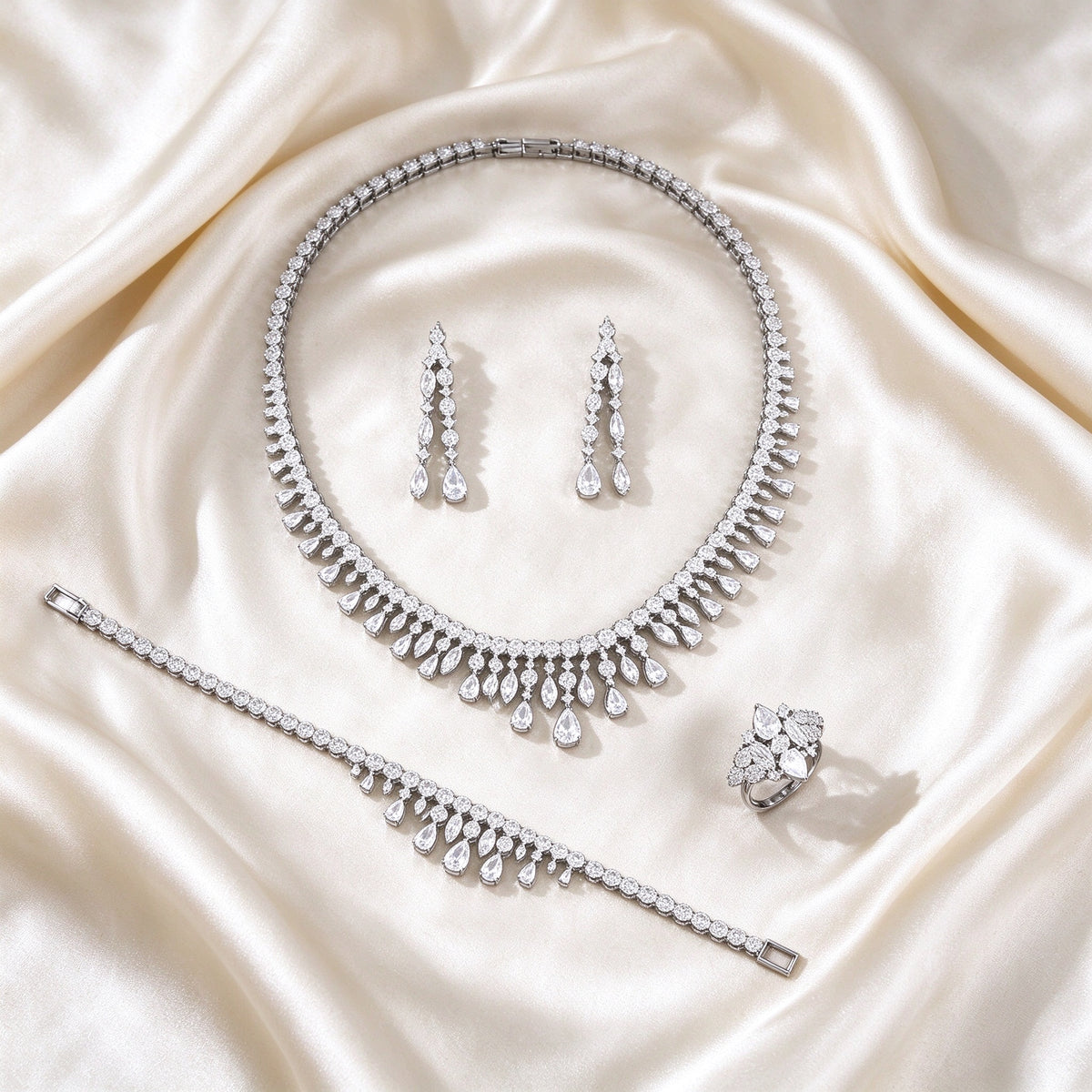 The Harper Crystal Parure – complete four-piece crystal parure laid flat on cream silk satin