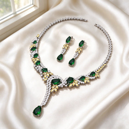 Flat lay of The Hadley Crystal Parure two-piece necklace and earrings on ivory silk satin