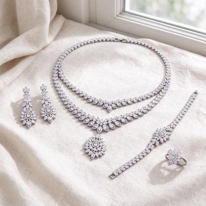 Flat lay of complete Clementine bridal set on warm ivory linen