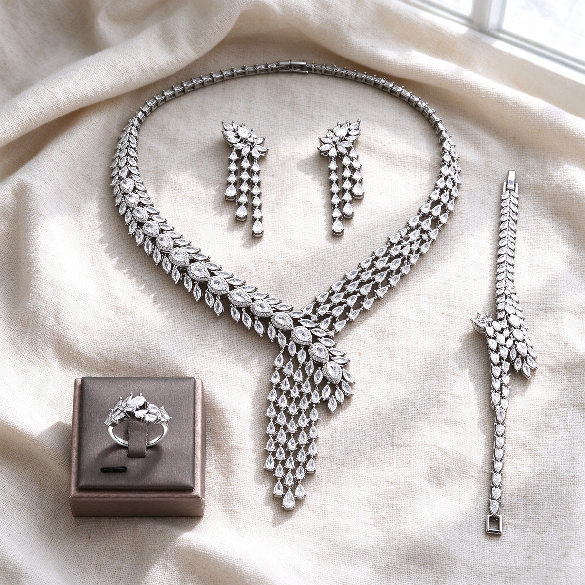 Overhead flat lay of The Marigold Wedding Suite four pieces on warm cream linen