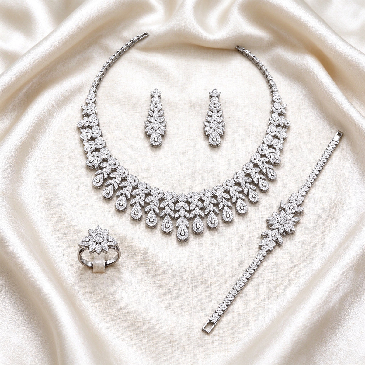 The Seraphine Bridal Set – complete four-piece set laid flat on cream silk