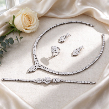 Flat lay of The Petal Bridal Set four-piece bridal set on ivory silk