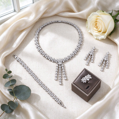 Flat lay of The Meadow Wedding Suite four-piece bridal set on ivory silk