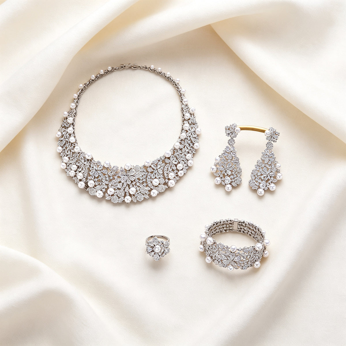 Flat lay of The Eclipse four-piece bridal jewelry set on ivory linen