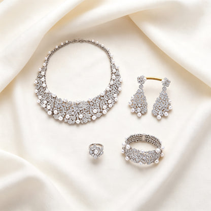Flat lay of The Eclipse four-piece bridal jewelry set on ivory linen