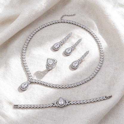 Silver-tone Fern bridal jewelry set flat lay on ivory linen