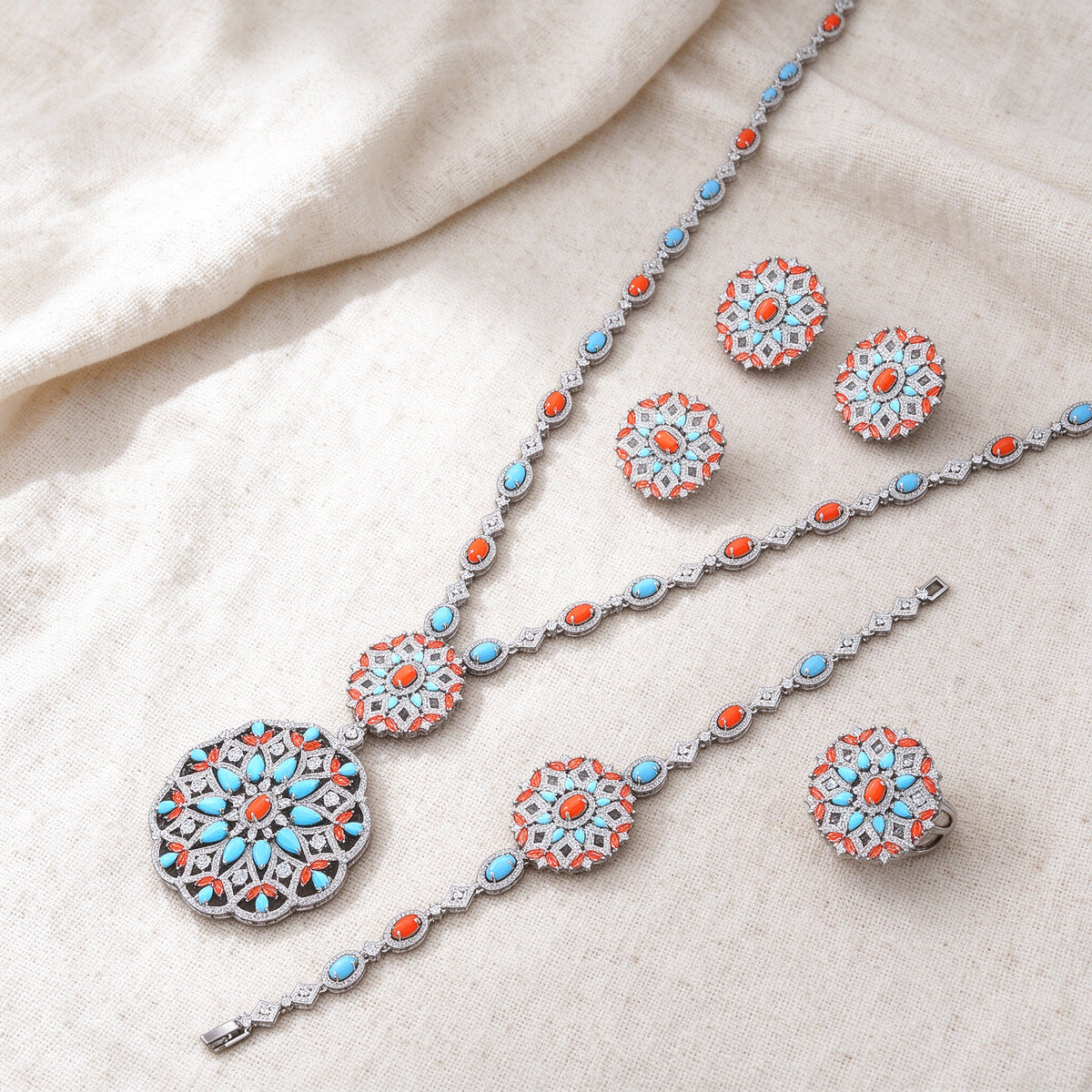 Overhead flat lay of The Bud Bridal Set four pieces on warm cream linen