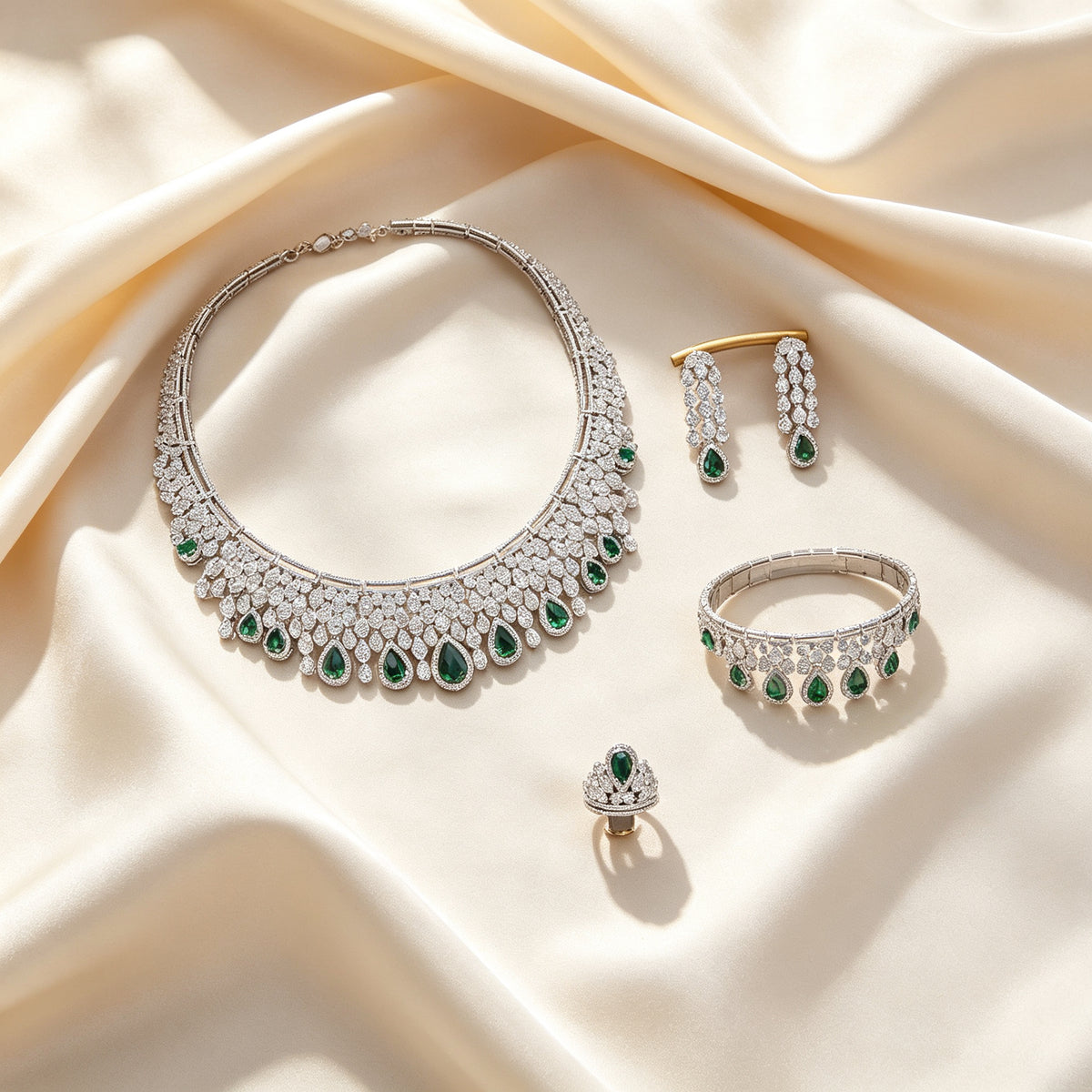 Flat lay of The Estelle Crystal Suite four-piece set on draped ivory champagne silk