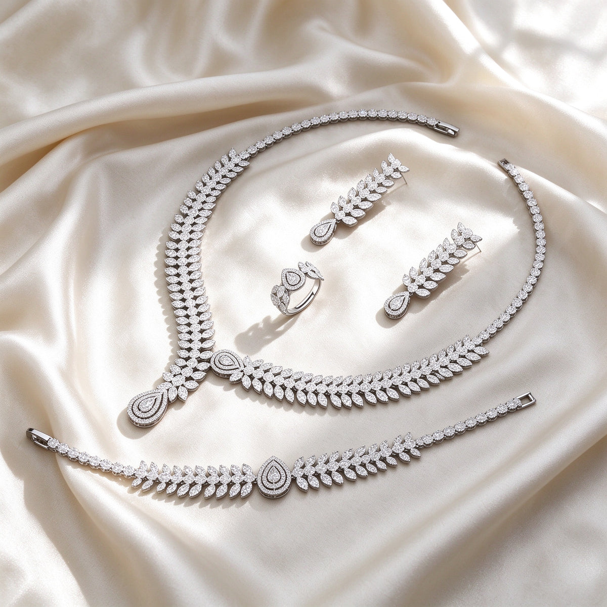 Flat lay of The Cordelia Wedding Suite four-piece set on ivory silk satin
