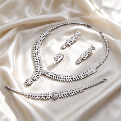 Flat lay of The Cordelia Wedding Suite four-piece set on ivory silk satin