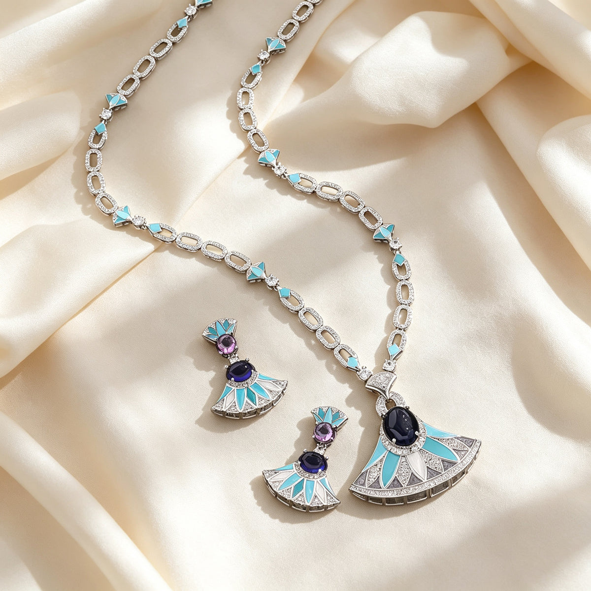 Flat lay of The Evangeline Crystal Suite necklace and earrings on ivory silk