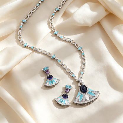 Flat lay of The Evangeline Crystal Suite necklace and earrings on ivory silk