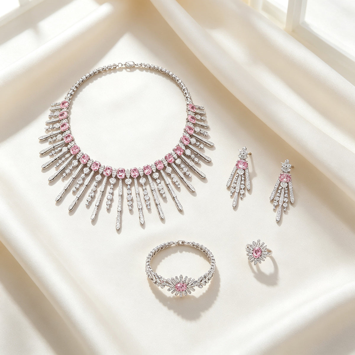 Flat lay of The Amara Wedding Parure four-piece set on ivory silk