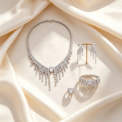 Flat lay of The Genevieve Bridal Set four-piece parure on draped ivory champagne silk