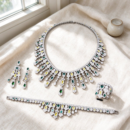 Overhead flat lay of The Dahlia Crystal Parure four pieces on warm cream linen
