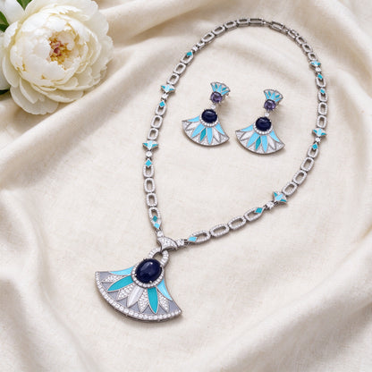 Flat lay of The Starlight Bridal Parure long necklace and fan earrings on ivory linen