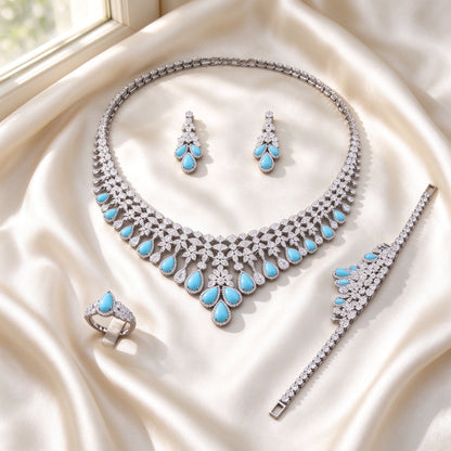 Flat lay of The Marlowe Wedding Suite four-piece set on ivory silk satin