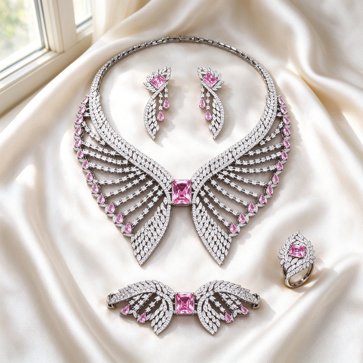 Flat lay of The Reagan Bridal Set four-piece wing-shaped set on ivory silk satin
