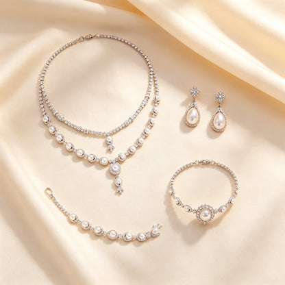 Flat lay of The Zenith four-piece bridal jewelry set on cream silk