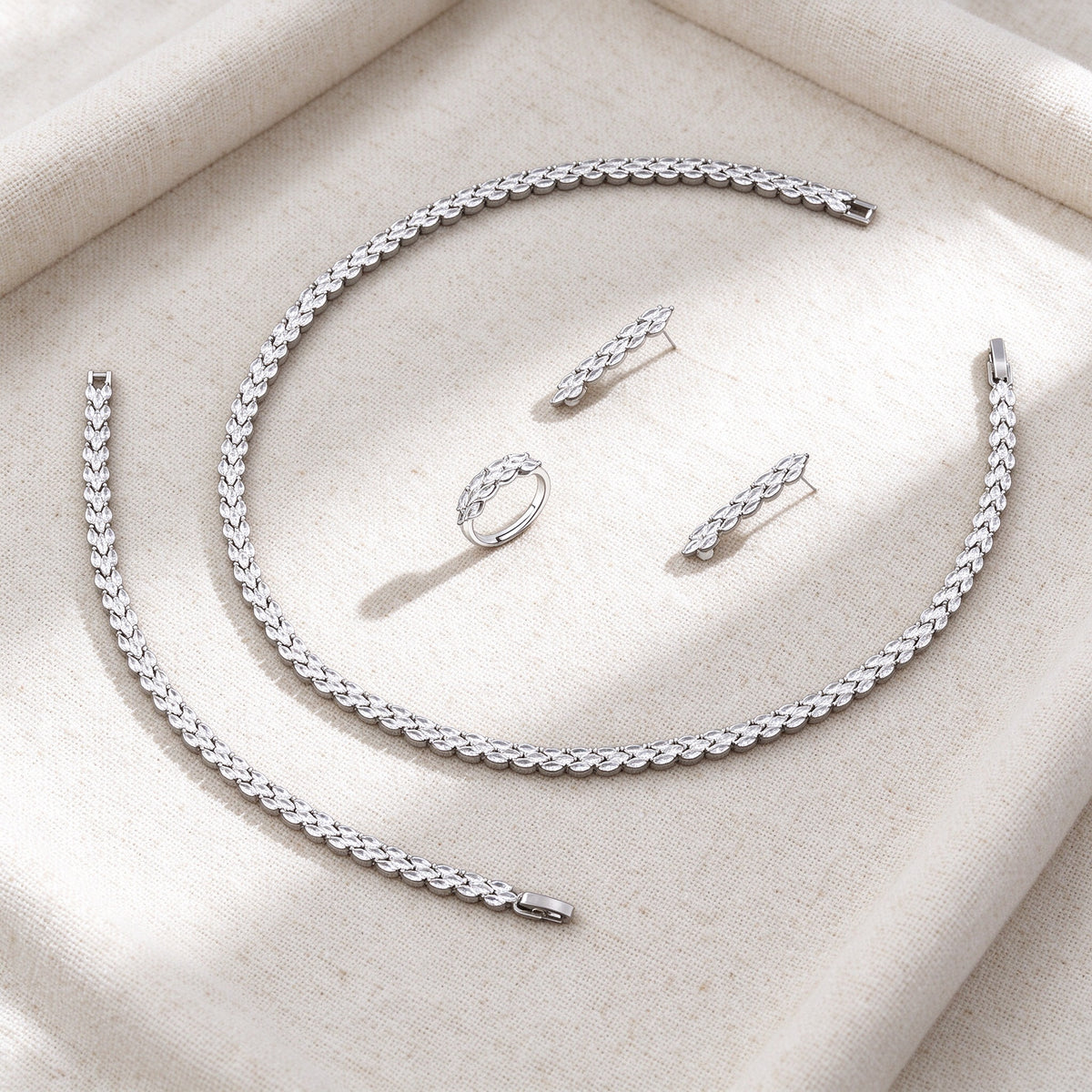 Overhead flat lay of The Thorn Wedding Suite four pieces on warm cream linen
