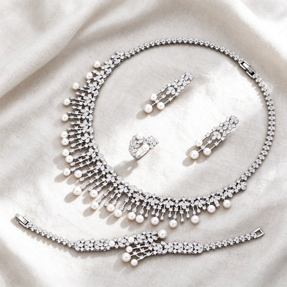 Silver-tone Rue bridal pearl jewelry set flat lay on ivory linen