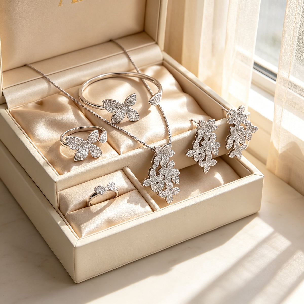 The Cosmo Bridal Parure complete set arranged in a cream leather jewelry gift box