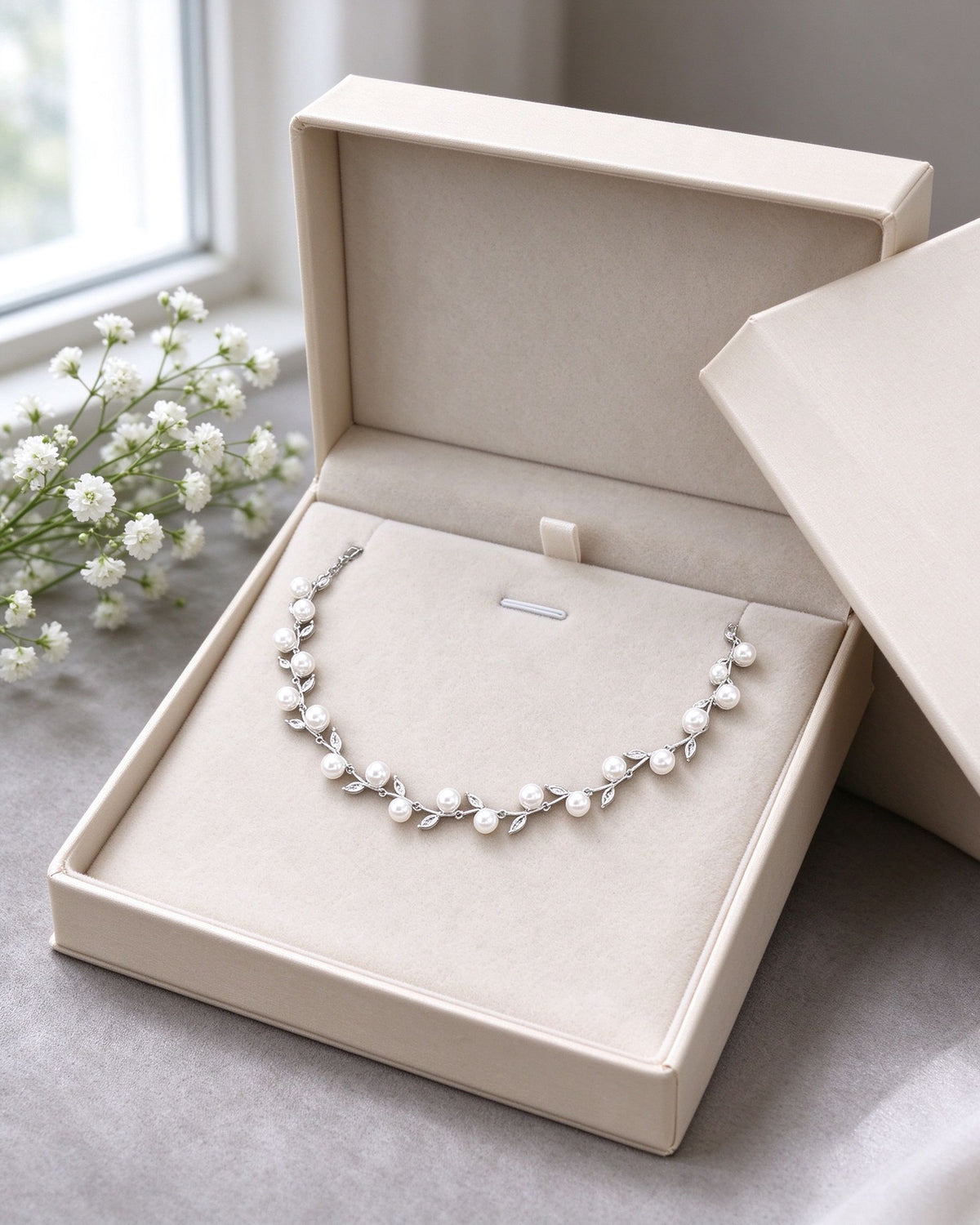 The Alpine Crystal Parure necklace presented in a cream ivory gift box