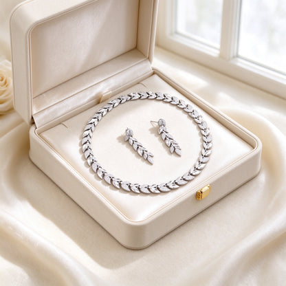 The Stella Bridal Parure laurel-leaf CZ necklace and earrings presented in an open ivory keepsake box lined with cream satin