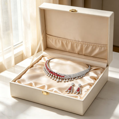 The Astra Wedding Suite collar and earrings arranged in a cream leather jewelry gift box