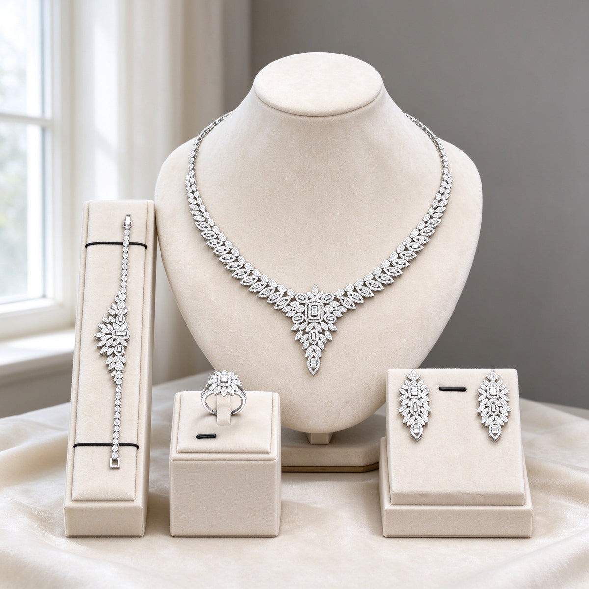 The Tiara Wedding Suite silver-tone clear CZ four-piece V-point fan necklace, earrings, bracelet and ring on ivory velvet bust